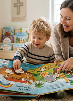 A mother and young child sitting on a living room rug reading My First Bible Stories storybook and placing Noah's Ark magnetic play pieces onto the open page.