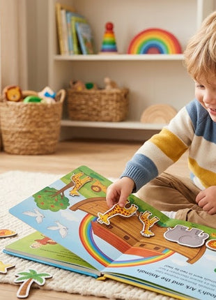 A smiling young boy sitting on a rug and playing with the Noah's Ark interactive magnetic storybook and animal pieces.