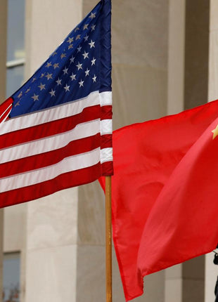 U.S. and Chinese flags at the Pentagon during a meeting between American and Chinese military officials, representing U.S.-China relations and national security.