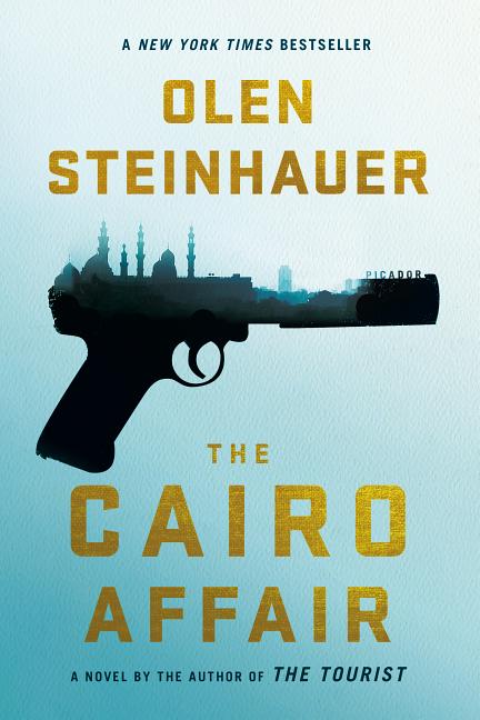 Book cover of The Cairo Affair by Olen Steinhauer featuring large gold typography on a pale blue background, a black handgun silhouette filled with a city skyline resembling Cairo, and text indicating “A New York Times Bestseller” and “A novel by the author of The Tourist.”