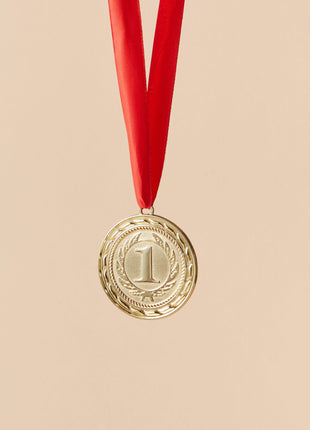 Gold award medal with red ribbon representing a Newbery Medal winning children’s book like The One and Only Ivan by Katherine Applegate