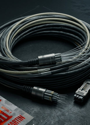 Hardcover edition of The Silver Fish thriller by Connor Martin next to a coil of realistic multi-core fiber optic cable and high-tech telecommunications connectors on a dark industrial surface.
