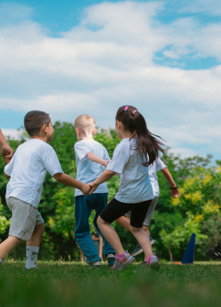 Children  playing in park illustrating friendship and inclusion themes from Wonder novel