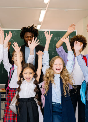 Diverse class celebrates with hands in the air symbolizing  unity and acceptance themes in Wonder children’s book